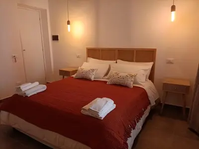 a bedroom with a large bed with towels on it at La Ciconella 2 in Palermo