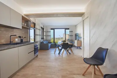 a kitchen and living room with a table and chairs at Villa Al-Kurum in Alcamo Marina