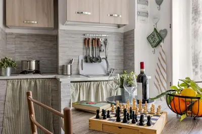 a chess board on a kitchen counter with a bottle of wine at Capo Sweet Home in Palermo