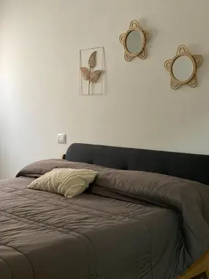 a bed in a bedroom with two mirrors on the wall at DADE Houses in Bagheria