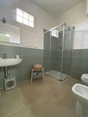 a bathroom with a shower and a sink and a toilet at DADE Houses in Bagheria