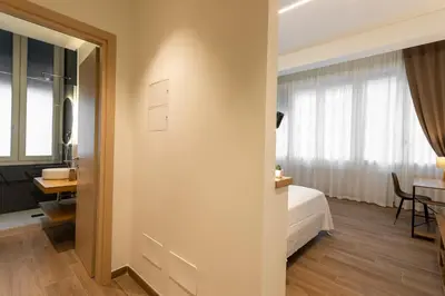 a bedroom with a bed and a desk and a table at Marina Rooms - Guesthouse in Palermo
