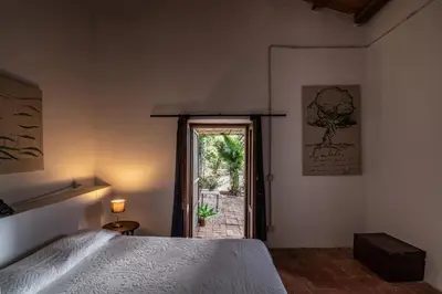 a bedroom with a bed and a door to a patio at Casa Panoramica in Terrasini