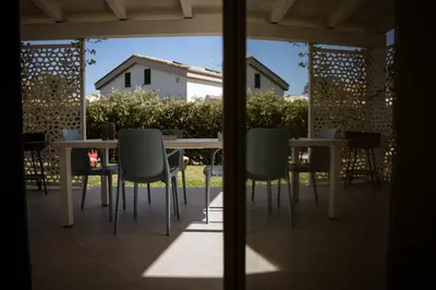 a table and chairs sitting on a patio at Residence Salinelle Beach Villa Panarea in Lascari