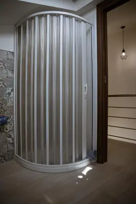 a room with a large glass wall with a sliding door at Residence Salinelle Beach Villa Panarea in Lascari