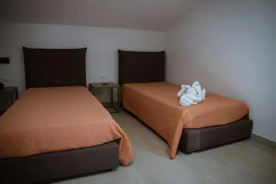 two beds sitting next to each other in a room at Residence Salinelle Beach Villa Panarea in Lascari