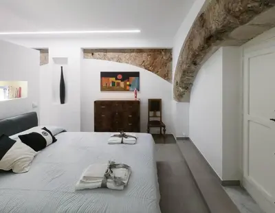 a bedroom with a bed with two towels on it at Genius Loci in Palermo
