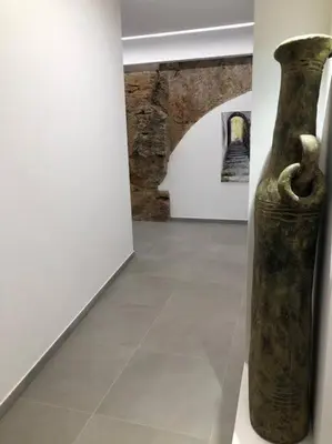 a vase sitting on a floor in a room at Genius Loci in Palermo