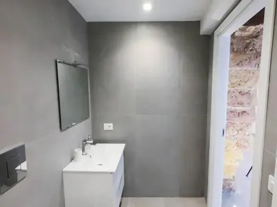 a bathroom with a white sink and a mirror at Genius Loci in Palermo