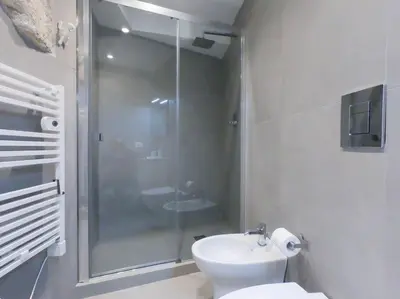 a bathroom with a shower and a toilet and a sink at Genius Loci in Palermo