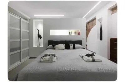 a bedroom with a large bed with two bags on it at Genius Loci in Palermo
