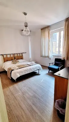 a bedroom with a bed and a chair in it at Casa di Giulia in Palermo