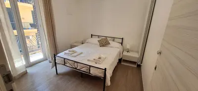 a small bedroom with a bed and a large window at Casa di Giulia in Palermo