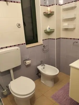 a bathroom with a toilet and a sink at Villetta al villaggio 101 pini in Campofelice di Roccella