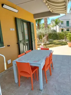 a blue table and chairs on a patio at Villetta al villaggio 101 pini in Campofelice di Roccella