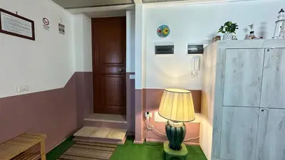 a lamp sitting on the floor next to a door at Casa Punta Barcarello, Sferracavallo fronte mare e tramonti da sogno, a due passi dalla splendida spiaggia di Mondello in Palermo