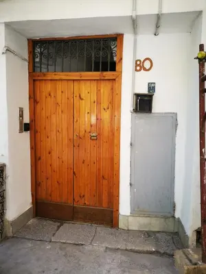 a wooden door of a building with a do sign at kappa's house a granni in Palermo