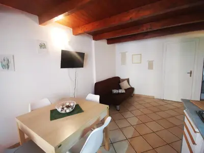 a living room with a wooden table and a couch at kappa's house a granni in Palermo