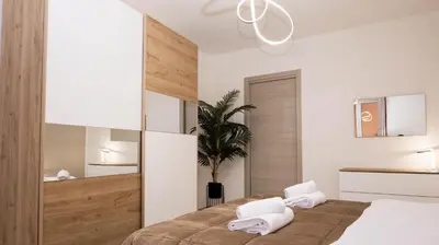 a bedroom with a bed and a potted plant at Leonetti in Carini