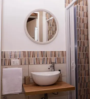 a bathroom with a white sink and a mirror at Leonetti in Carini