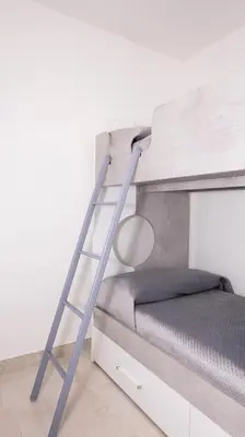 a ladder next to a bunk bed in a room at Leonetti in Carini