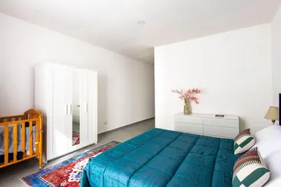 a bedroom with a blue bed and a mirror at Civico 61 in Palermo