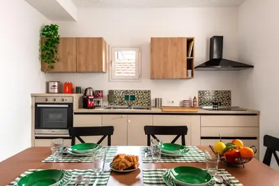 a kitchen with a table with green plates on it at Civico 61 in Palermo