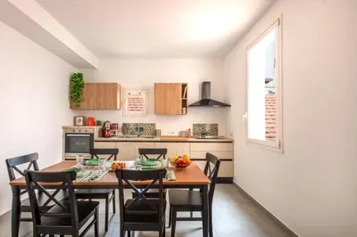 a kitchen and dining room with a table and chairs at Civico 61 in Palermo
