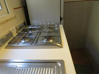 a row of burners on a stove in a kitchen at Loft with terrace in the city centre in Palermo