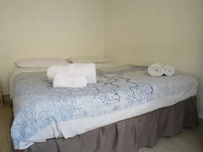 a bed with two pillows and towels on it at Loft with terrace in the city centre in Palermo