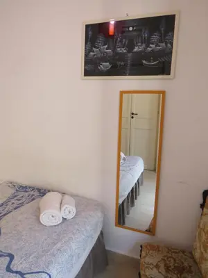 a bedroom with a mirror and a bed with towels at Loft with terrace in the city centre in Palermo