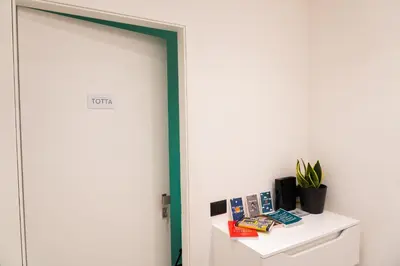 a room with a door and a shelf with books at Casa Chicotta- Libertà in Palermo