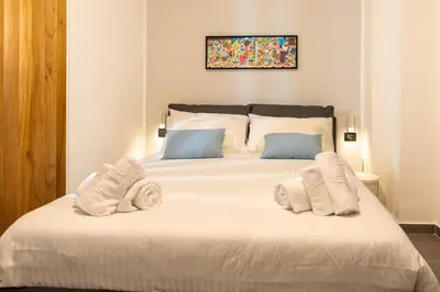 a bedroom with a large white bed with towels on it at Casa Chicotta- Libertà in Palermo