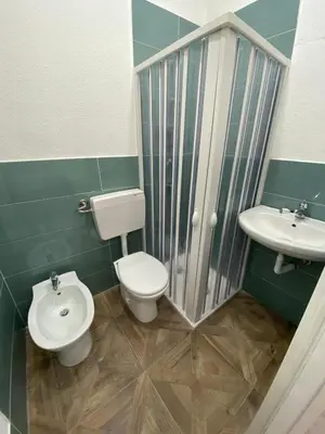 a bathroom with a toilet and a sink at I Conti della Zisa in Palermo