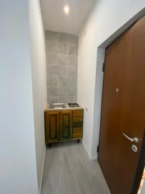 a bathroom with a sink and a wooden door at I Conti della Zisa in Palermo