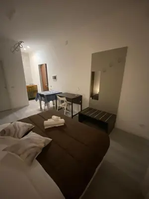 a bedroom with a large bed and a table at I Conti della Zisa in Palermo