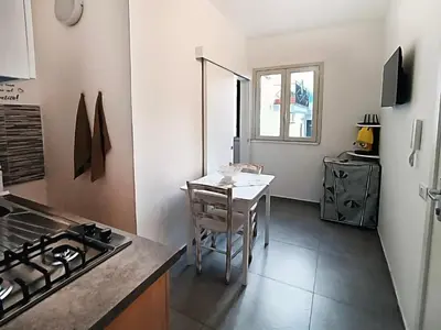 a small kitchen with a table and a stove at Mare Blu in Palermo