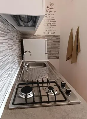 a kitchen with a stove and a sink at Mare Blu in Palermo