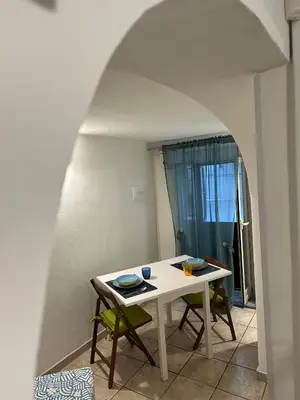 a white table and chairs in a room at Blue Charm Exclusive Apartment in Palermo