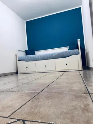 a bedroom with a bed with a blue wall at Blue Charm Exclusive Apartment in Palermo