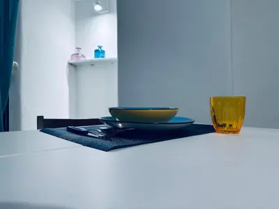 a bowl and a glass sitting on a table at Blue Charm Exclusive Apartment in Palermo