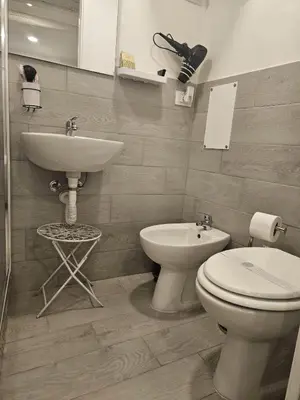 a bathroom with a toilet and a sink at All'Oro Suite & go in Palermo