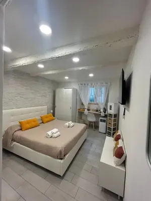 a bedroom with a bed and a desk in it at All'Oro Suite & go in Palermo