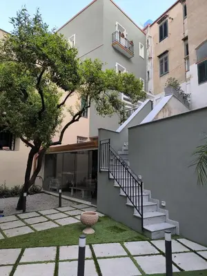 a house with a staircase in front of a building at HrD Luxury Rooms in Palermo