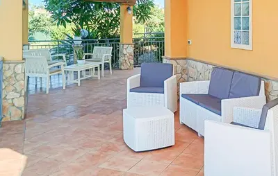 a patio with chairs and tables on a building at Stunning Home In Trabia in Trabia