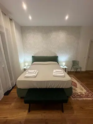 a bedroom with a bed with two towels on it at Rosalia Holiday Home in Palermo