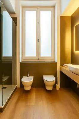 a bathroom with a toilet and a sink and two windows at GoriziaHome in Palermo