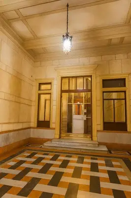 a lobby with a chandelier and a checkered floor at GoriziaHome in Palermo
