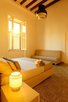 a bedroom with a bed and a couch at GoriziaHome in Palermo