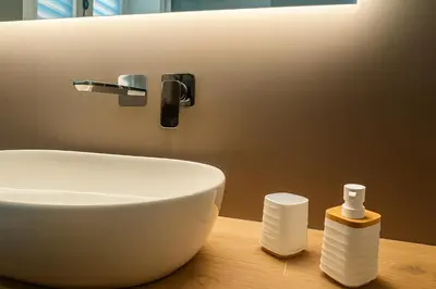 a bathroom with a white sink on a wooden table at GoriziaHome in Palermo
